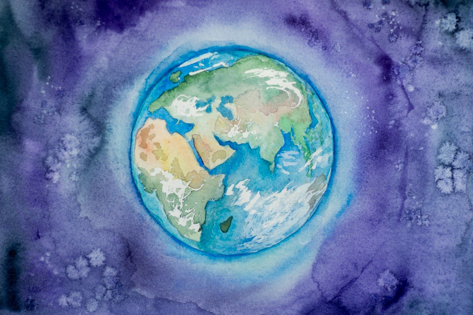 Photo by Elena Mozhvilo a watercolor painting of the earth in space